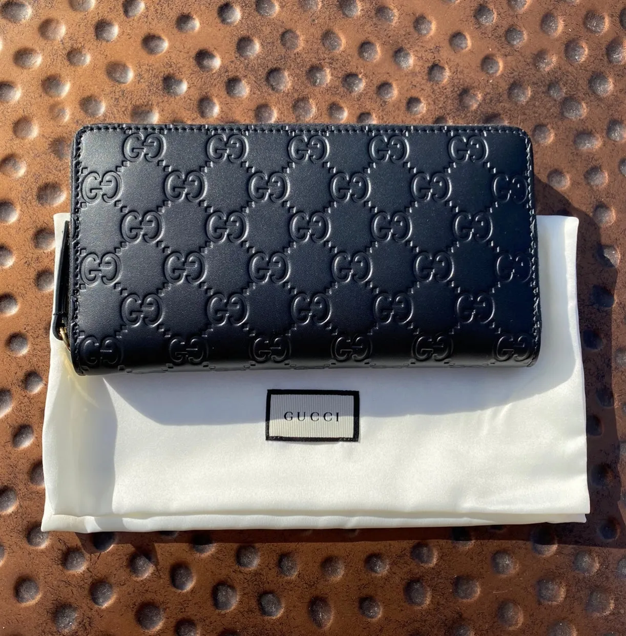 Gucci Interlocking GG Embossed Leather Zip Around Wallet in Black