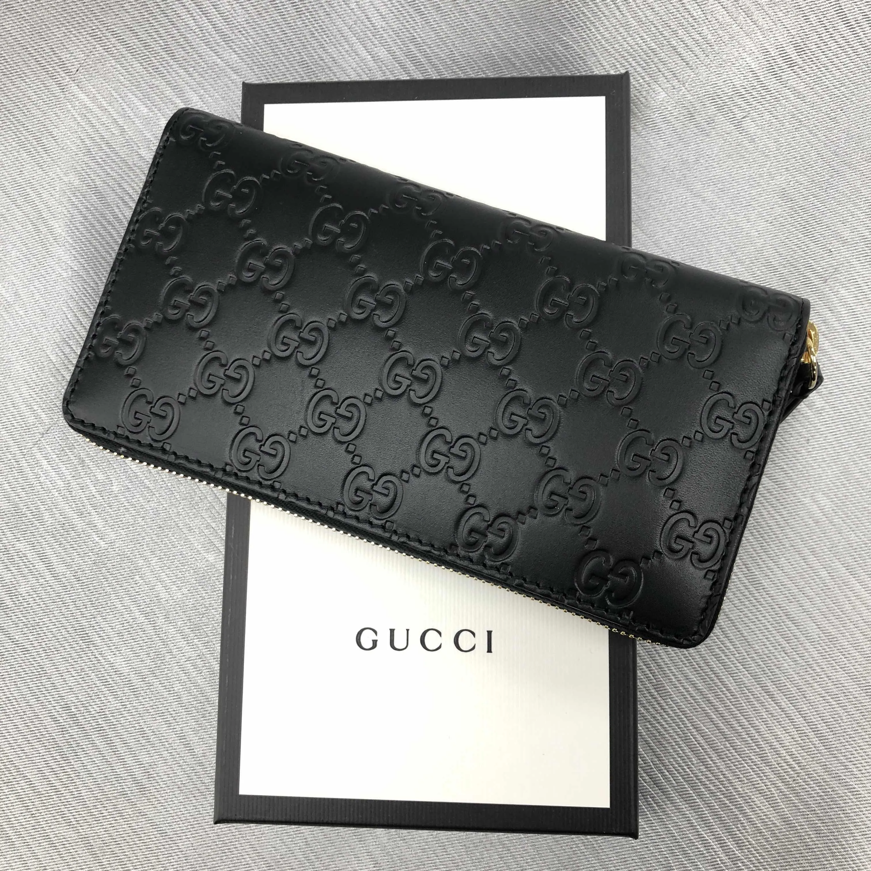 Gucci Interlocking GG Embossed Leather Zip Around Wallet in Black