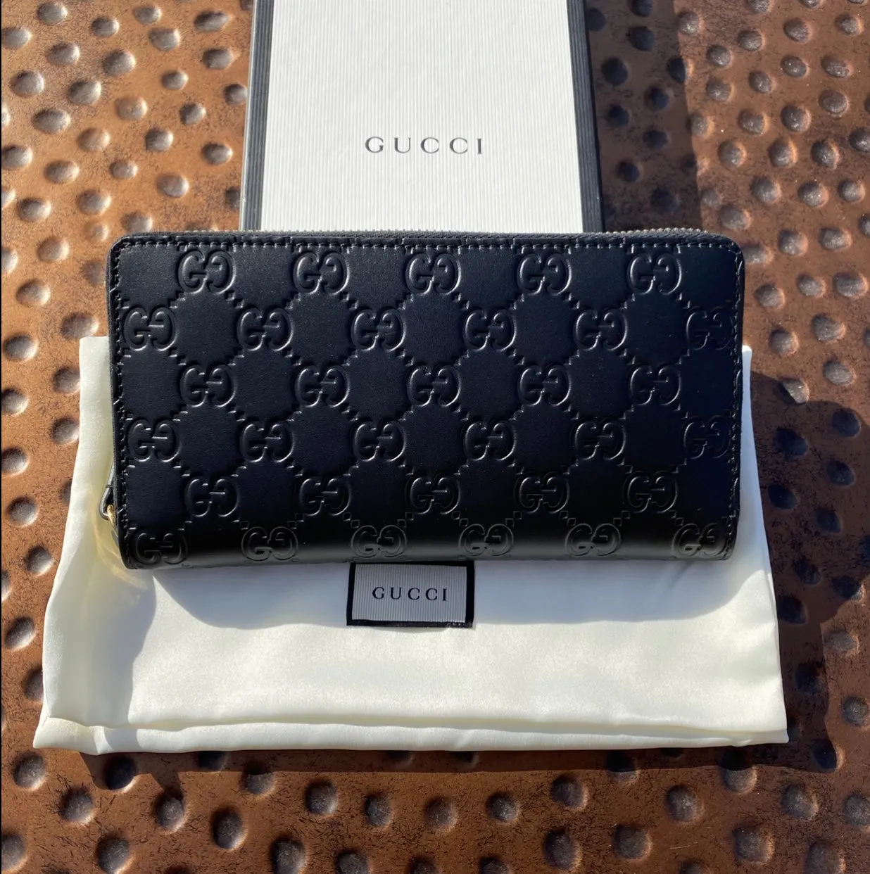 Gucci Interlocking GG Embossed Leather Zip Around Wallet in Black