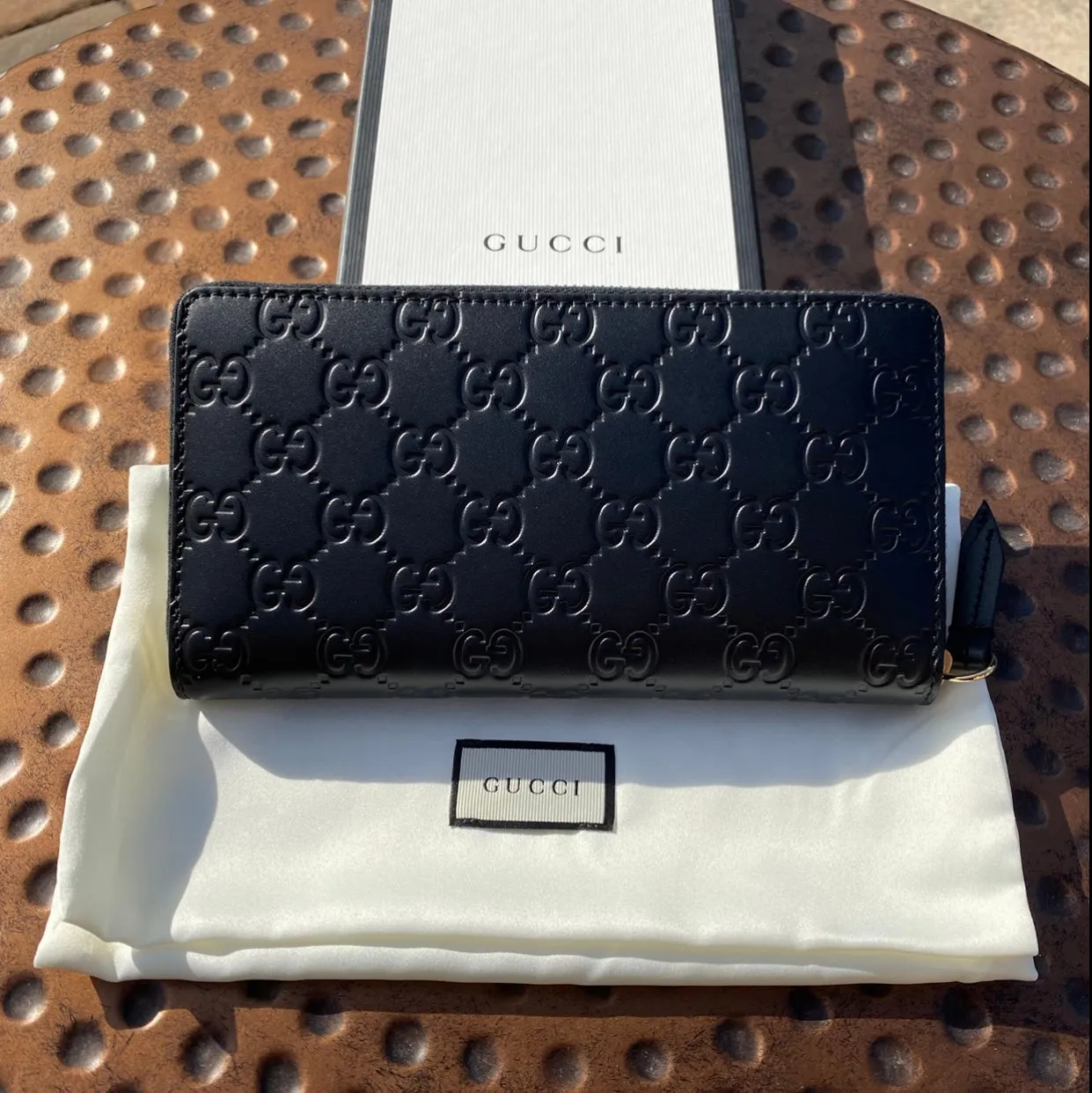 Gucci Interlocking GG Embossed Leather Zip Around Wallet in Black