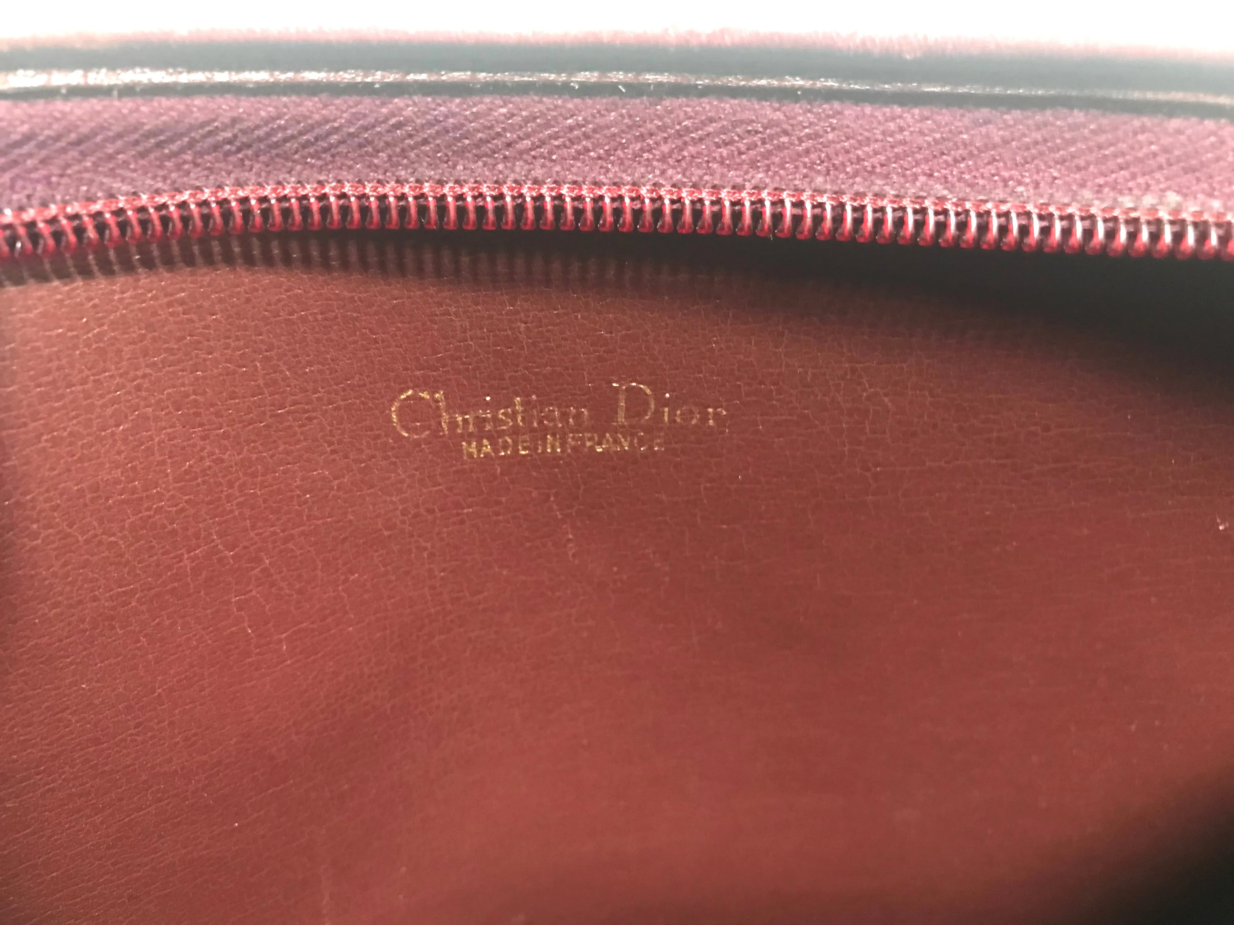 Vintage Christian Dior wine red leather clutch shoulder bag with engraved logo at center. Classic and beautiful purse. 060905r4