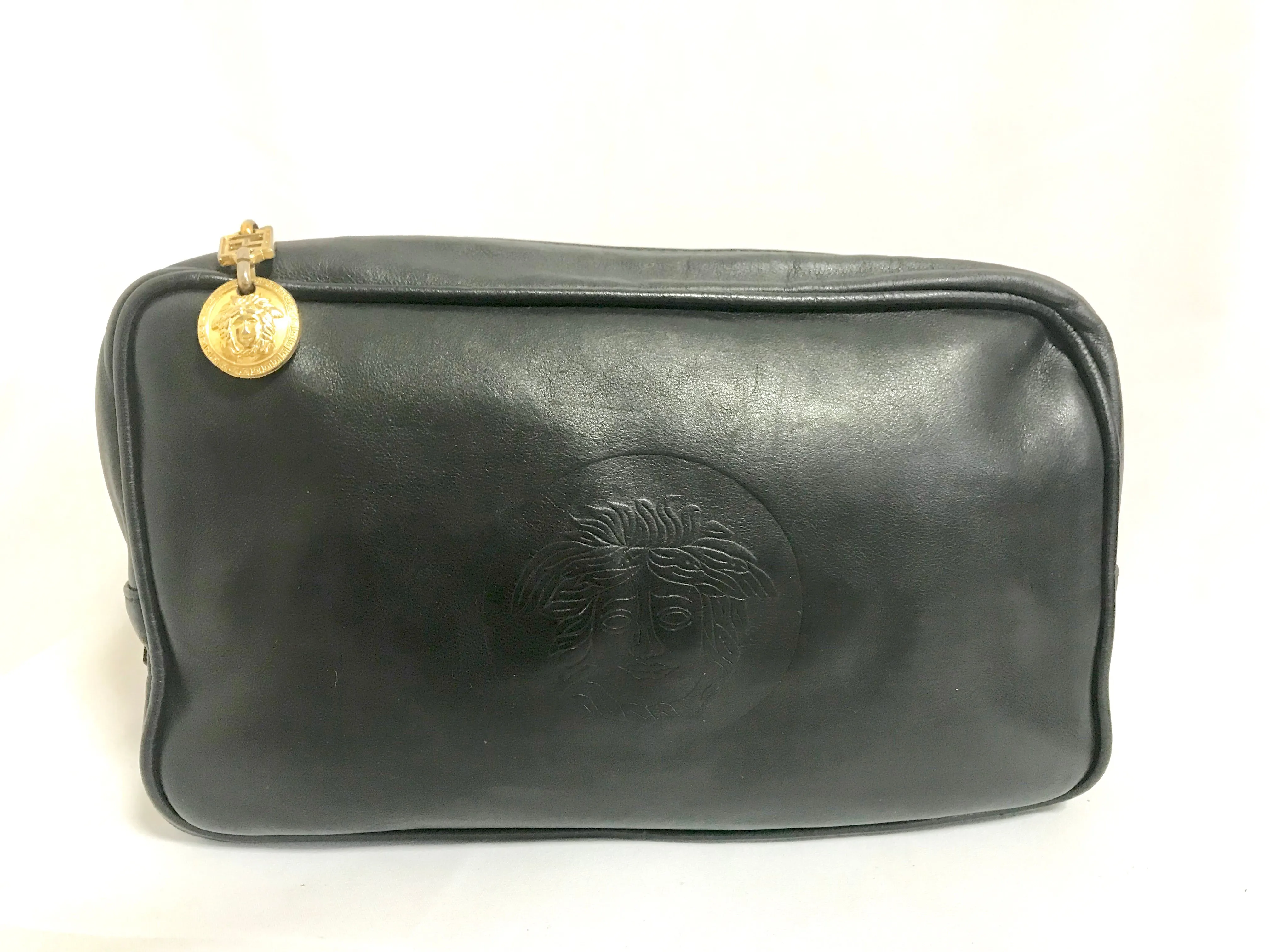 Vintage Gianni Versace black leather purse pouch, case bag with its iconic medusa face and golden logo motif charm. Unisex bag. 061122re1