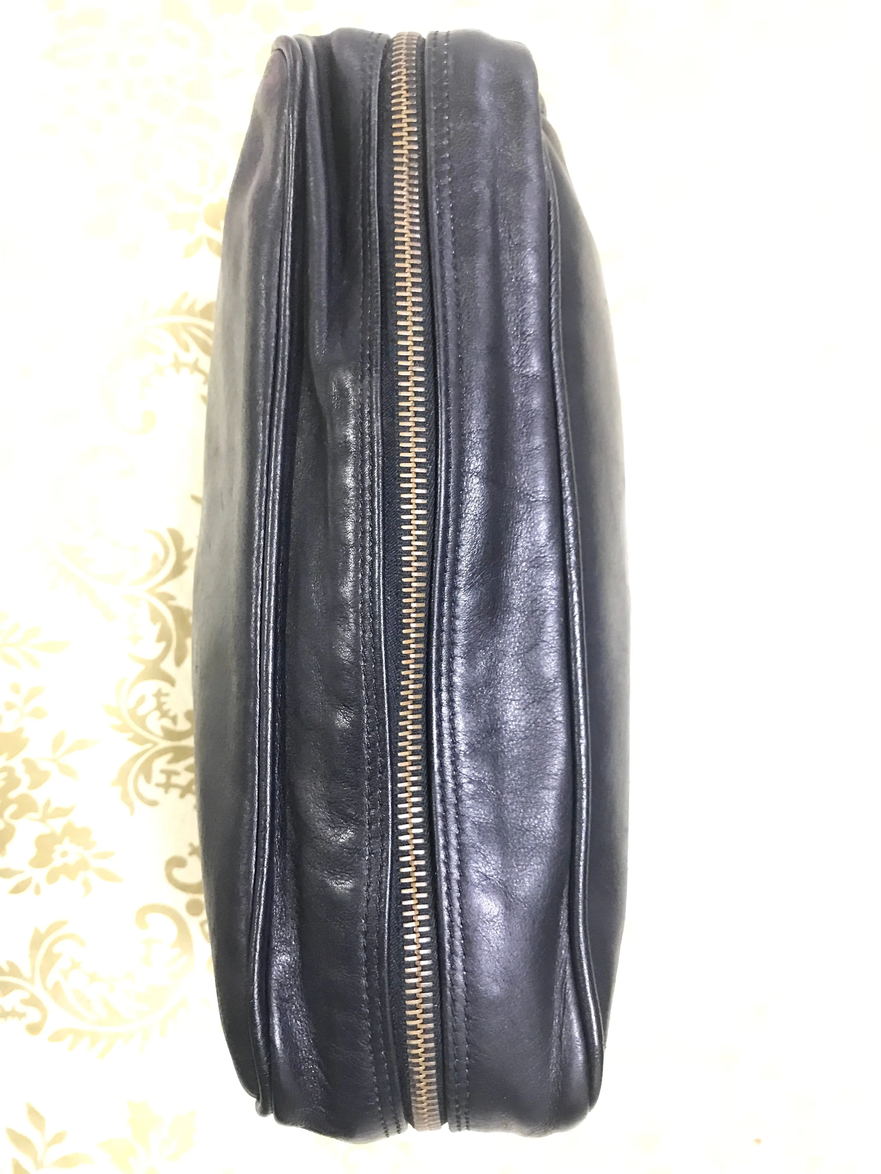 Vintage Gianni Versace black leather purse pouch, case bag with its iconic medusa face and golden logo motif charm. Unisex bag. 061122re1
