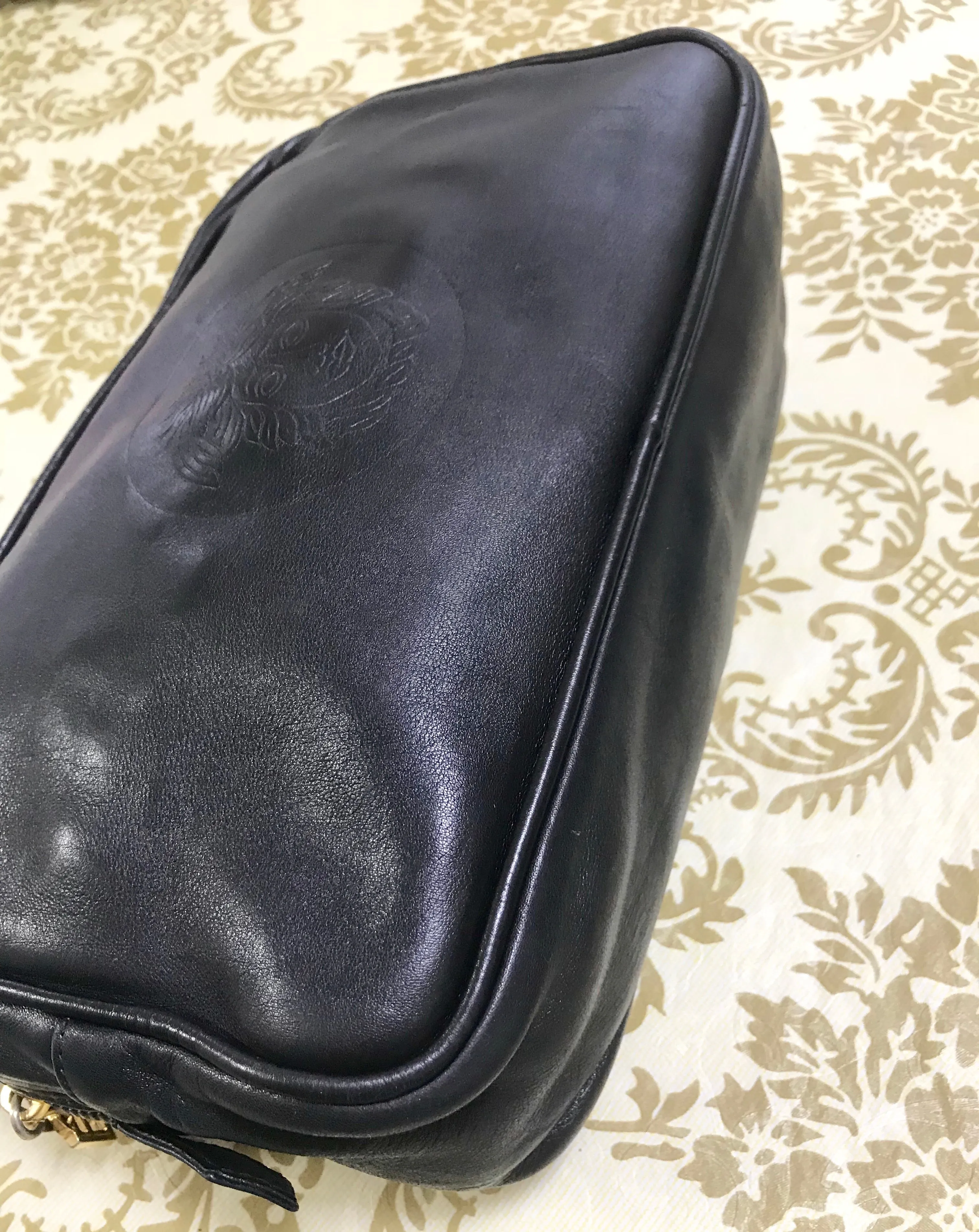 Vintage Gianni Versace black leather purse pouch, case bag with its iconic medusa face and golden logo motif charm. Unisex bag. 061122re1