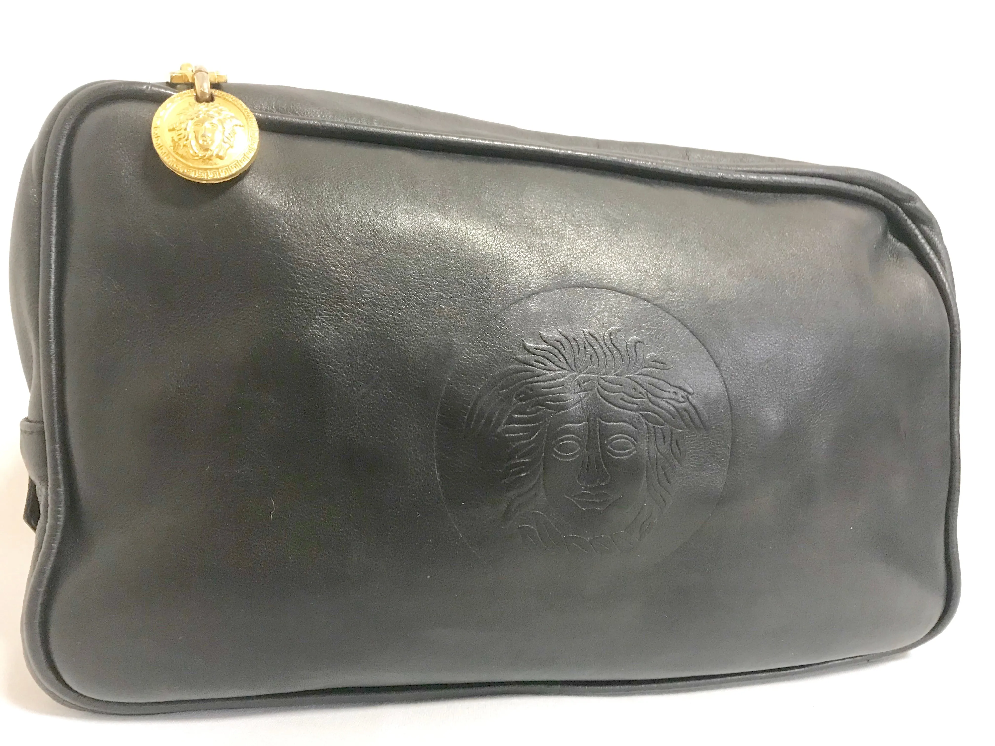Vintage Gianni Versace black leather purse pouch, case bag with its iconic medusa face and golden logo motif charm. Unisex bag. 061122re1