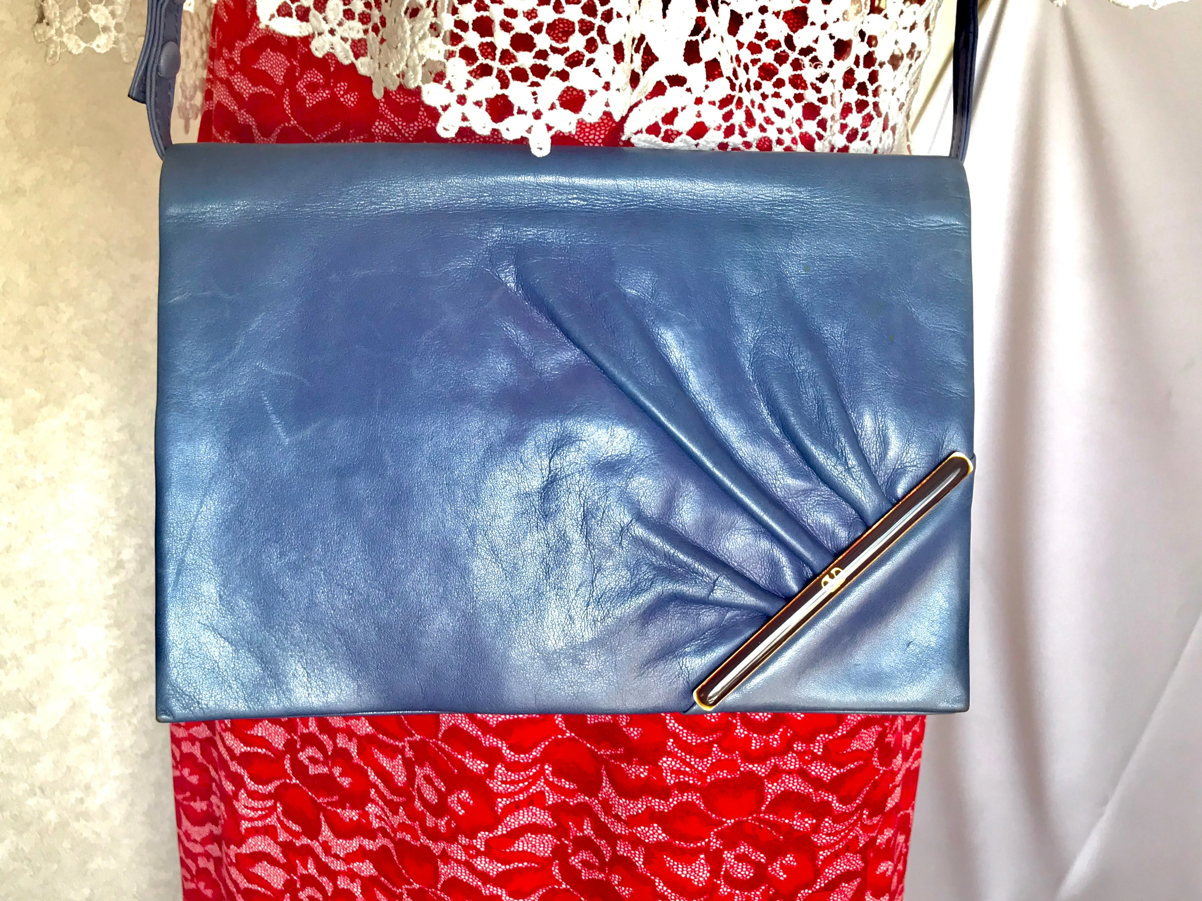 Vintage Valentino Garavani blue leather clutch shoulder bag with brown and golden logo plate at front. Gathered design.