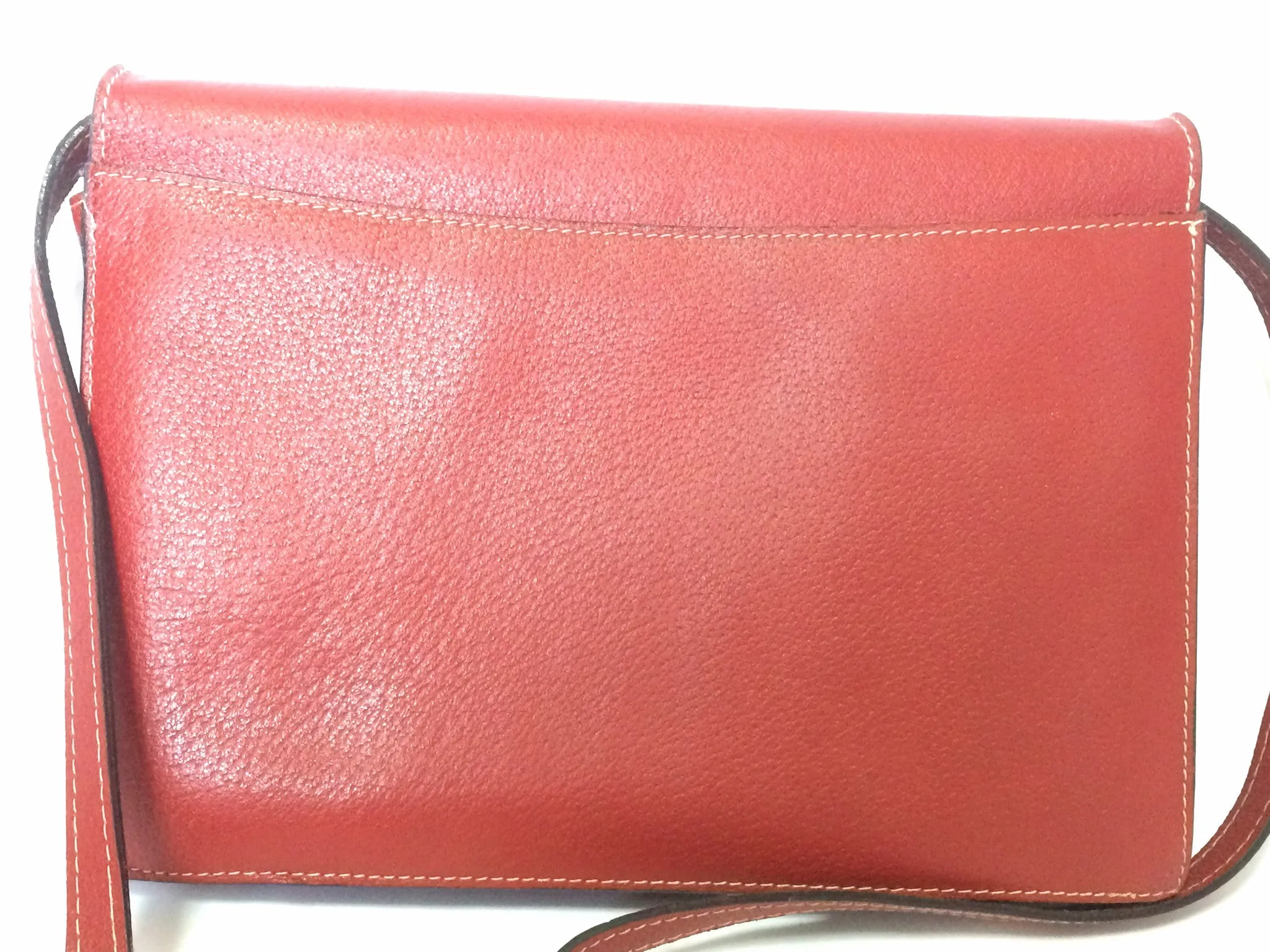 Vintage Valentino Garavani red pigskin shoulder clutch bag with unique logo stitch mark.