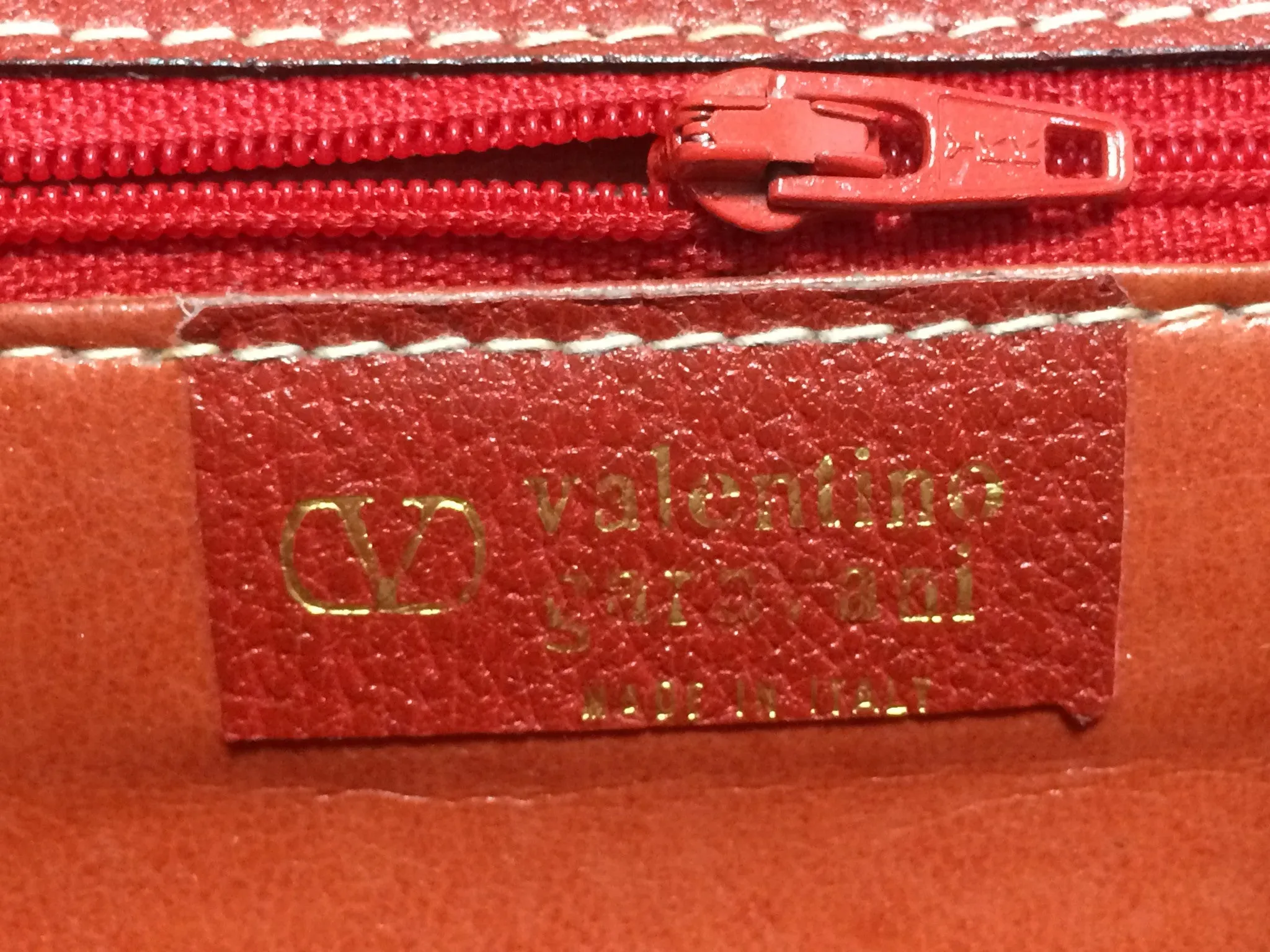 Vintage Valentino Garavani red pigskin shoulder clutch bag with unique logo stitch mark.